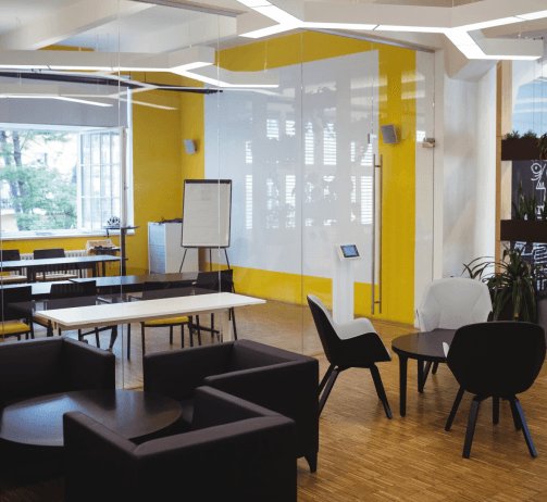 Workspace with yellow accents and whiteboard